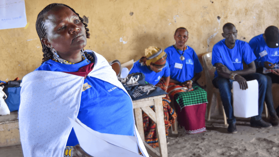 A worker from THE RAIN WORKERS in front of a class