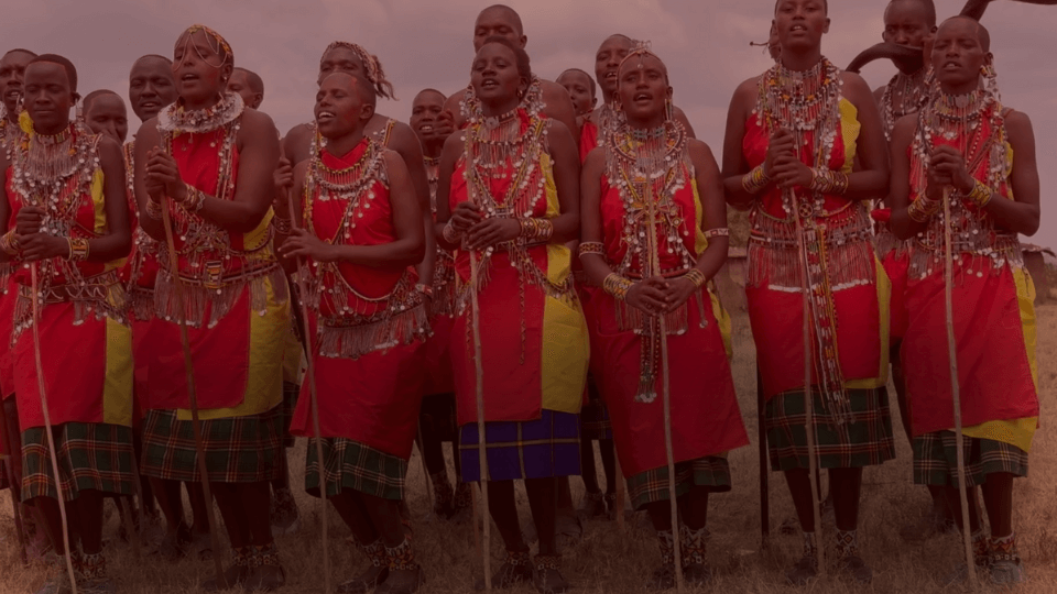 Maasai woman and men dancing.