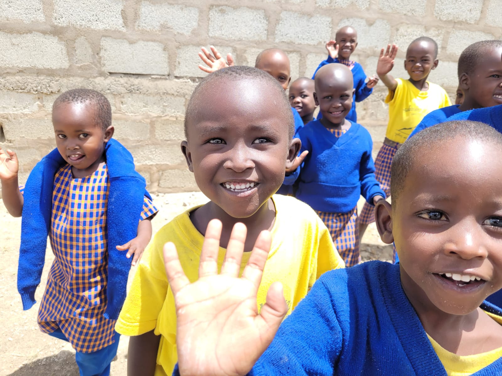 Maasai Kids smiling and waving